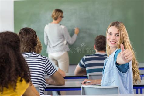 Female Student Gesturing Thumbs Up In Class Stock Photo Image Of