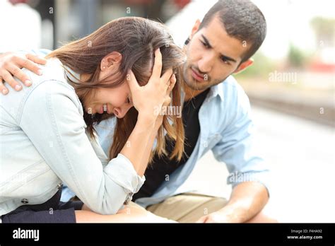Side View Of A Muslim Man Comforting A Sad Caucasian Girl Mourning In A