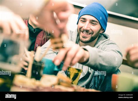 Happy Guy With Friends Eating Finger Food And Drinking Beer At Pub