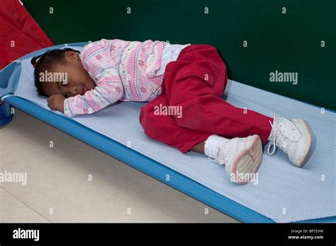 4 Year Old Preschool Girl Lying On A Cot During Nap Time At School