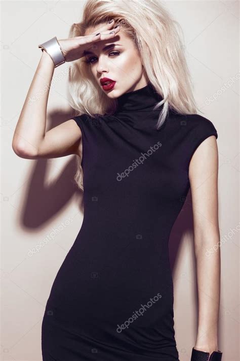 beautiful sexy blonde girl with sensual lips fashion hair black dress and gold accessories