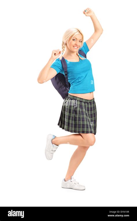 Full Length Portrait Of An Excited Female Student With Raised Hands