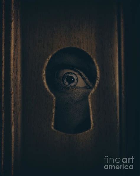 Closeup Photograph Of A Human Eye Looking Through A Door Keyhole In A