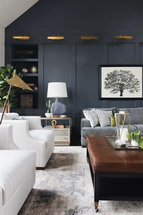 While they can be more expensive than other types of chairs, once you sit in a modern easy chair, you will understand why so many people have these in their living room. A row of brass picture lights are fitted to a dark blue ...