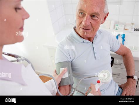 Doctor Patients Taking Blood Pressure Stock Photo Alamy
