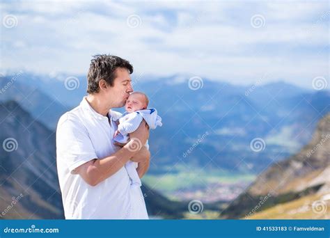 Young Father Kissing His Newborn Baby In Mountains Stock Image Image