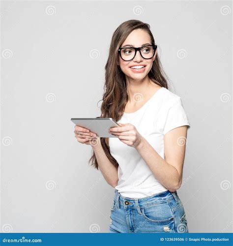 Portrait Of Beautiful Female Student Wearing Nerd Glasses Holding