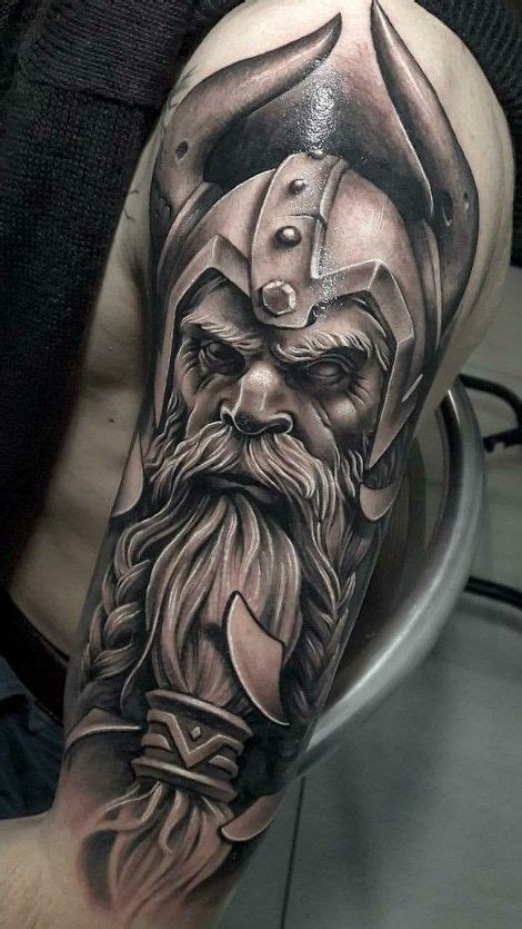 A Mans Half Sleeve With An Old Viking Tattoo On His Arm And Shoulder