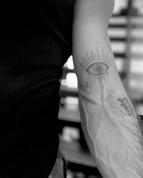 Evil Eye Tattoo Located On James Locks Bicep