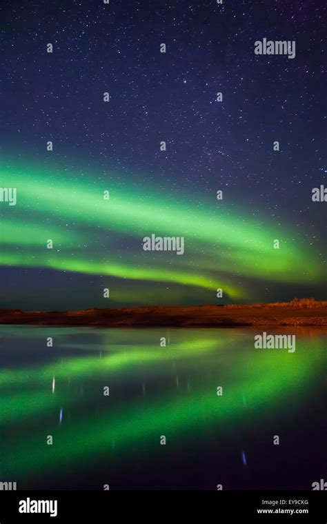 Northern Lights Reflected Over The Noatak River On A Clear Night