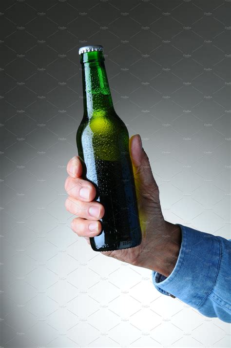 hand holding beer bottle high quality food images creative market