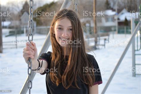 Photo Of A Teens Girl In A Swings Holding The Chain While Laughing On A
