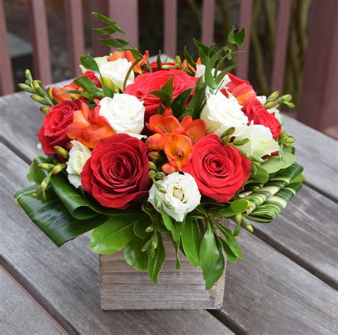 Does 1800 flowers deliver in a box? Flower box with roses, lisianthus, freesia and green ...