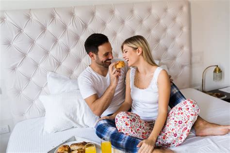 Young Couple Having Having Romantic Times In Bedroom Stock Photo