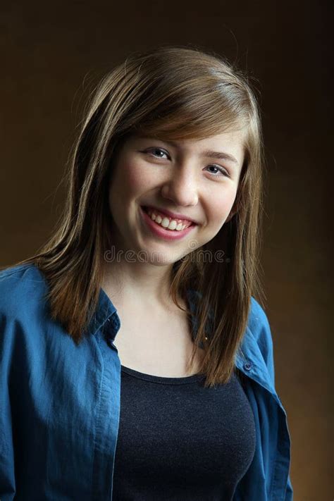 Portrait Of Smiling Beautiful Teenage Girl With Long Brown Hair Stock