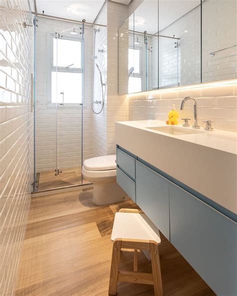 A Bathroom With A Sink Toilet And Shower Stall In It S Own Area