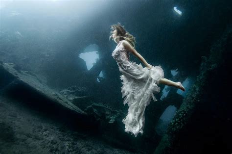 Models Dive Meters To An Underwater Shipwreck In Bali For A