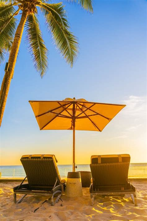 Beautiful Tropical Nature Umbrella Chair With Palm Tree Around Beach