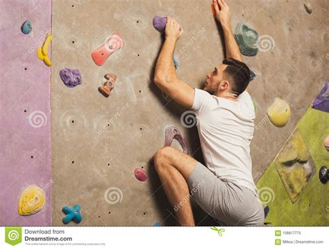 Young Man Climbing Artificial Rock Wall At Gym Stock Image Image Of Grab Chalk 108817775