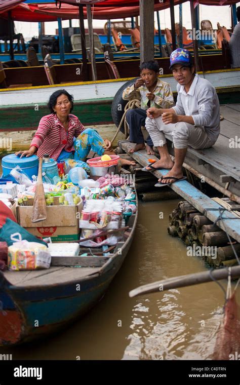 Two Local Cambodian People Eating At A Floating Market Boat On Tonle