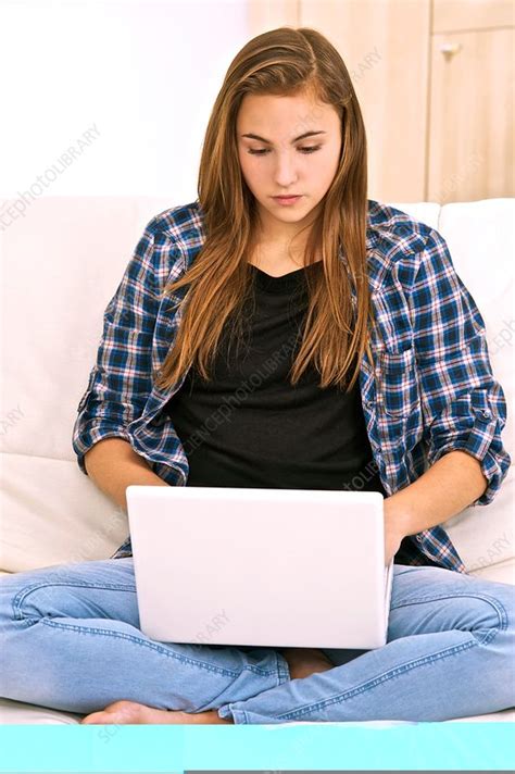 Teenager using a laptop computer - Stock Image - C014/0094 - Science Photo Library