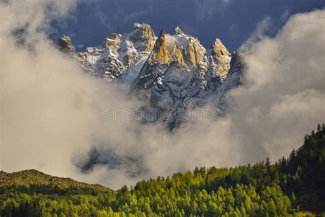Aiguilles Mountain Peaks Through Clouds And Blue Sky Chamonix France
