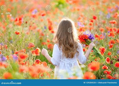 Adorable Little Girl With A Bouquet Of Wildflowers With Hands Sp Stock