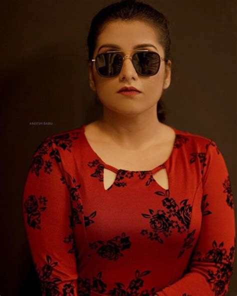 A Woman Wearing Sunglasses Is Posing For The Camera With Her Hands On