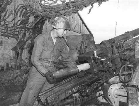 Photo A Member Of The 131st Field Artillery Battalion Loading A 105mm