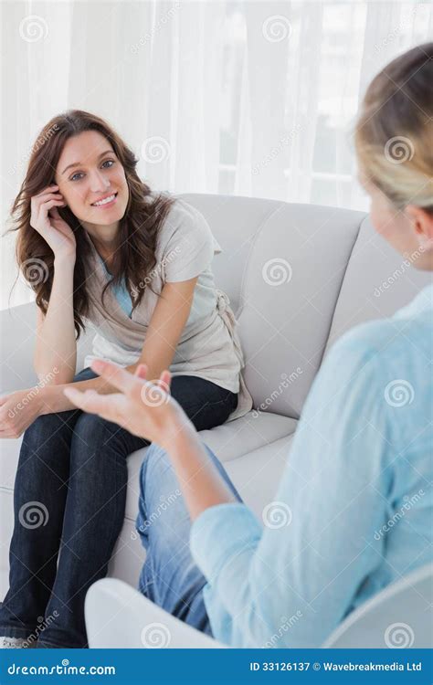 Happy Woman Sitting With Her Therapist Talking To Her Stock Image