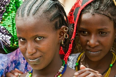 Portrait Of Two Fulani Girls Dressed In Colorful Traditional Clothes In