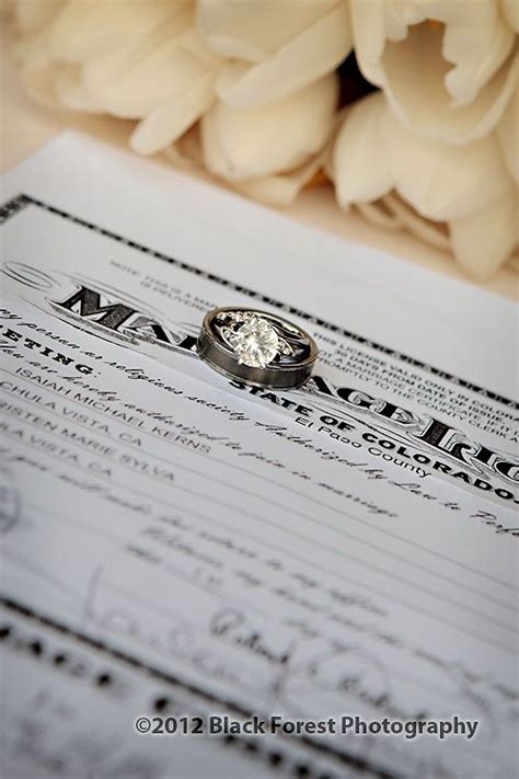 A Wedding Ring Sitting On Top Of A Marriage Certificate