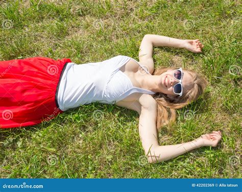 Girl Lying On The Grass Arms Outstretched Stock Image Image Of