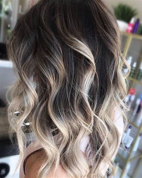 Light blonde highlights peeping through the medium length, wavy and smooth hair look very pleasing. Balayage Brown Hair Ideas For This Season