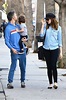 Family time! Anne Hathaway sports denim blouse and black trousers for ...