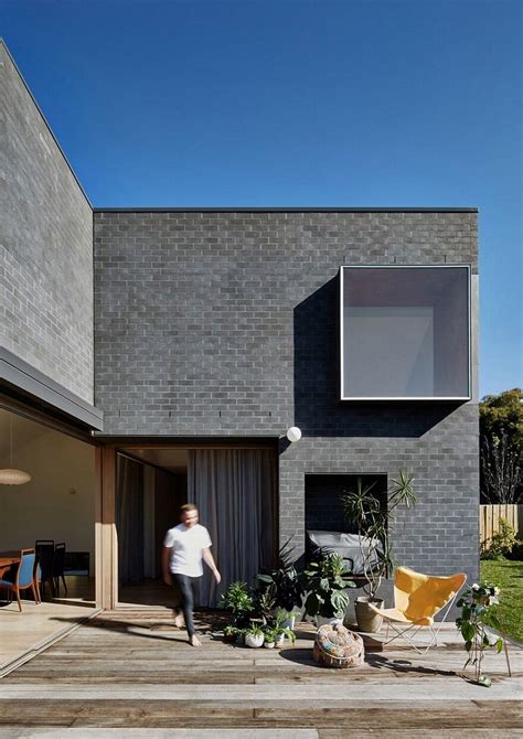 This Black Brick House Features Generous Spaces with a High Degree of Flexibility