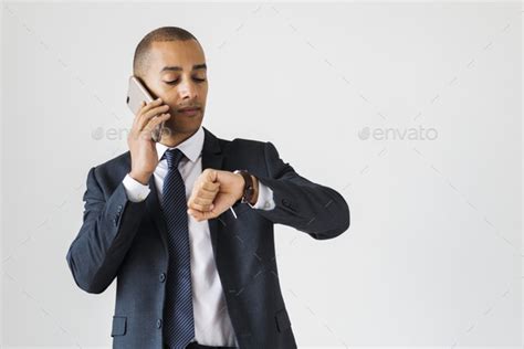 Businessman Talking On Call Checking Time Fro Wrist Watch Stock Photo