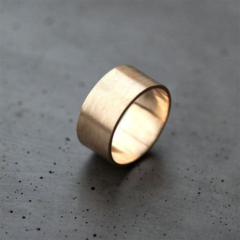 A Gold Ring Sitting On Top Of A Table