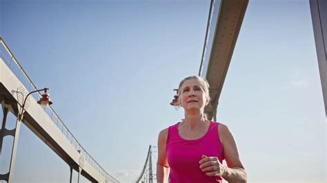 Satisfied Senior Woman Enjoys Running On Pedestrian Bridge Stock Video Footage Sbv