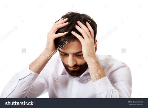 Stock Photo Young Depressed Businessman Holding His Head 258809138