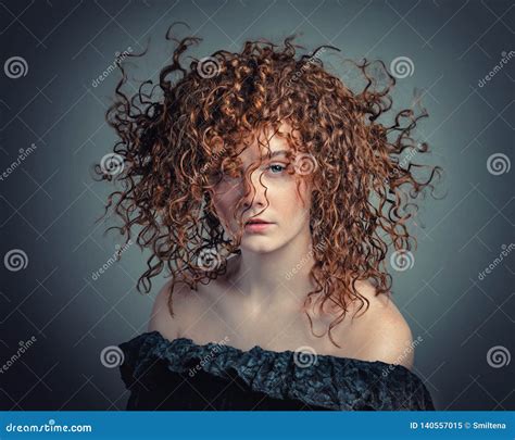 Portrait Of Beautiful Young Woman With Flying Curly Hair Stock Image