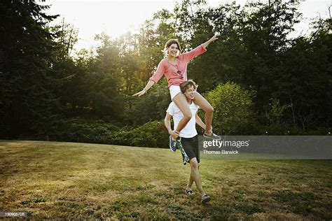 Young Woman Riding On Mans Shoulders Photo Getty Images