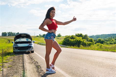 Beautiful Woman Hitchhiking By A Broken Car Girl Stands At His Car And Waiting For Help A