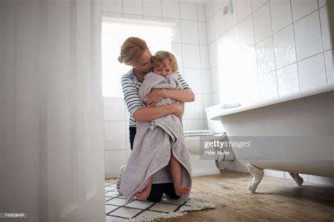 Mother And Daughter In Bathroom Mother Wrapping Daughter In Bath Towel