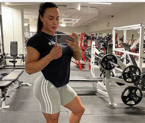 A Woman Is Taking A Selfie In The Gym With Her Cell Phone While