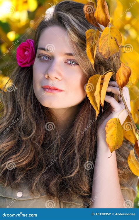 Beautiful Model With Autumn Leaves And Fall Yellow Garden Background