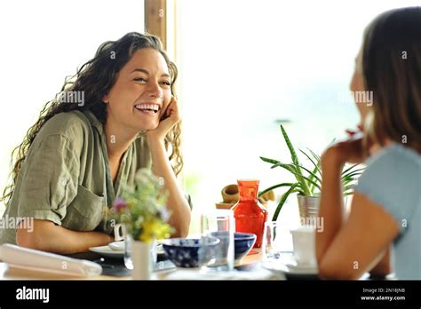 Two Happy Friends Talking In A Restaurant Stock Photo Alamy