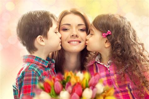 Happy Mother Kissed By Her Daughter And Son Stock Photo By ©svetaorlova