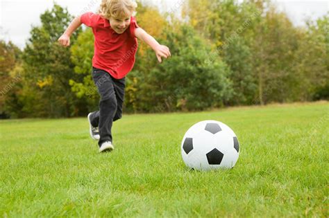 Boy Playing With Soccer Ball In Field Stock Image F0054665