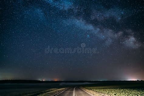 Blue Night Starry Sky Above Country Asphalt Road In Countryside And